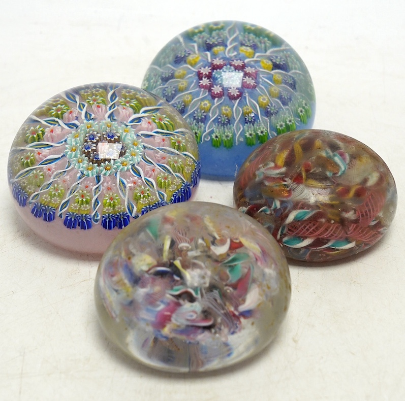 Two Perthshire millefiori glass paperweights and two scrambled glass paperweights, largest 7cm wide. Condition - fair